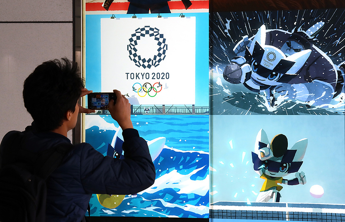 Japan s share prices rebounded over 19,000 yen level March 25, 2020, Tokyo, Japan   A man takes a picture of a large illustration of Tokyo 2020 Olympic Games mascot Miraitowa in Tokyo on Wednesday, March 25, 2020. Japanese government and International Olympic Committee  IOC  agreed to postpone Tokyo 2020 Olympic Games on March 24 for a year due to the global outbreak of the new coronavirus.    Photo by Yoshio Tsunoda AFLO 