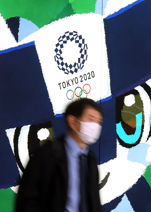 Japan s share prices rebounded over 19,000 yen level March 25, 2020, Tokyo, Japan   A pedestrian passes before a large illustration of Tokyo 2020 Olympic Games mascot Miraitowa in Tokyo on Wednesday, March 25, 2020. Japanese government and International Olympic Committee  IOC  agreed to postpone Tokyo 2020 Olympic Games on March 24 for a year due to the global outbreak of the new coronavirus.    Photo by Yoshio Tsunoda AFLO 