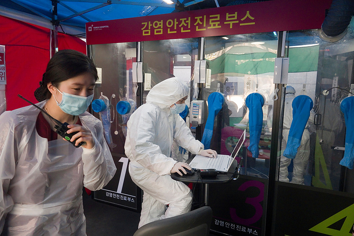 The world efforts to ride out the COVID 19 crisis Single person COVID 19 testing booth, Mar 18, 2020 : Medical team works at a single person COVID 19 testing facilities outside a hospital in Seoul, South Korea. The H plus Yangji Hospital set up public telephone booth style COVID 19 testing facilities in which medical team safely takes a swab from the patient inside the booth by use of gloves equipped on the booth and communicate with the patient by intercom. The single person booth to test for novel coronavirus enables medical team to avoid being exposed directly to patients and it reduces time for disinfection. South Korean government restricted religious gatherings, indoor sports activities and visits to nightclubs and other entertainment venues to slow the new coronavirus pandemic that emerged in China late last year.  Photo by Lee Jae Won AFLO   SOUTH KOREA 