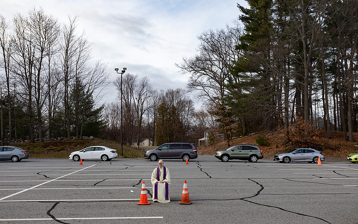 drive up confessions during Covid 19 April 1, 2020, Chelmsford, Massachusetts, USA: Father Brian Mahoney at drive up confessions in the parking lot of St. Mary  Catholic Church during Covid  19 pandemic in Chelmsford.  Photo by Keiko Hiromi AFLO 