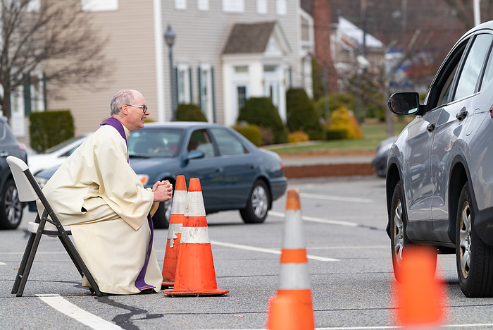 drive up confessions during Covid 19 April 1, 2020, Chelmsford, Massachusetts, USA: Father Brian Mahoney hears at drive up confessions in the parking lot of St. Mary   Catholic Church during Covid 19 pandemic in Chelmsford.  Photo by Keiko Hiromi AFLO 