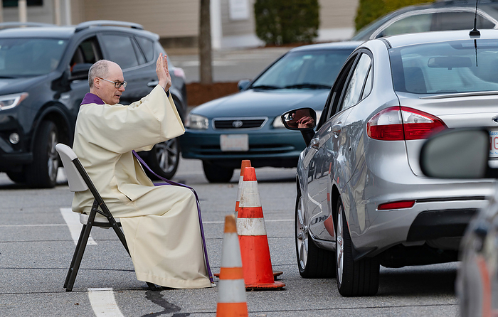drive up confessions during Covid 19 April 1, 2020, Chelmsford, Massachusetts, USA: Father Brian Mahoney hears at drive up confessions in the parking lot of St. Mary   Catholic Church during Covid 19 pandemic in Chelmsford.  Photo by Keiko Hiromi AFLO 