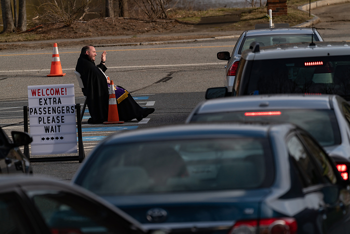 drive up confessions during Covid 19 April 1, 2020, Chelmsford, Massachusetts, USA: Father Corey Bassett Tirrell hears at drive up confessions in the parking lot of St. Mary  Catholic Church during Covid 19 pandemic in Chelmsford.