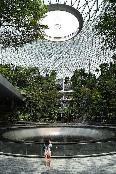 Covid19, Jewel Changi Airport, Singapore APR 10, 2020   Covid 19: A woman takes photo of No waterfall at Jewel Changi Airport after Singapore government has announced Circuit Breaker measurement take effect from 07 Apr to 04 May of the COVID19 novel coronavirus