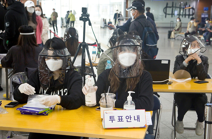 South Korea s early voting for the April 15 general elections in Seoul South Korea s early voting for the April 15 general elections, Apr 10, 2020 : While a camera checks voters  temperature, election officials wearing plexiglass wait to give plastic gloves and hand sanitizer to voters to prevent virus infection at a polling station on the first day of the two day early voting for the April 15 general elections in Seoul, South Korea. To prevent COVID 19 coronavirus infection, voters were asked to stand at least 1 meter away from each other at polling stations. They were advised to wear face masks and were allowed to cast ballots after using hand sanitizers and putting on gloves. The quadrennial elections will fill the 300 seat unicameral National Assembly of South Korea.  Photo by Lee Jae Won AFLO   SOUTH KOREA 