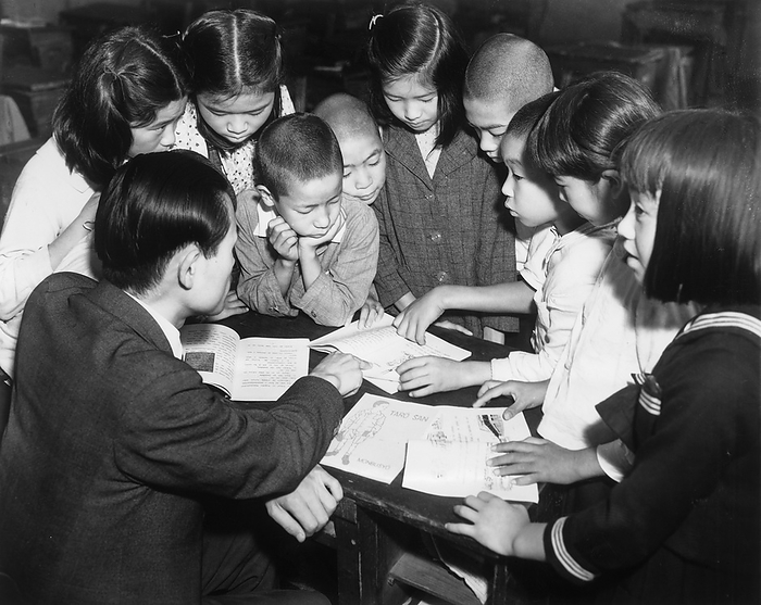 160306 0008   Learning Romanized Japanese Japanese elementary school students learning alphabetized Japanese crowd around a teacher, 1948  Showa 23 .  Between 1948 and 1950  Showa 25 , teaching materials with romanized script were distributed among Japan s elementary school to be used in teaching subjects other than the Japanese language  Kokugo, kokugo . Between 1948 and 1950  Showa 25 , teaching materials with romanized script were distributed among Japan s elementary schools to be used in teaching subjects other than the Japanese language  Kokugo, kokugo .  The results showed that students in this post war romanization education experiment did not fall behind their peers. They even suggested that they could have made faster progress than students who did They even suggested that they could have made faster progress than students who did not use romanized materials.  They even suggested that they could have made faster progress than students who did not use romanized materials. They even suggested they could make faster progress than students who did not use romanized materials.  Photo by MeijiShowa AFLO