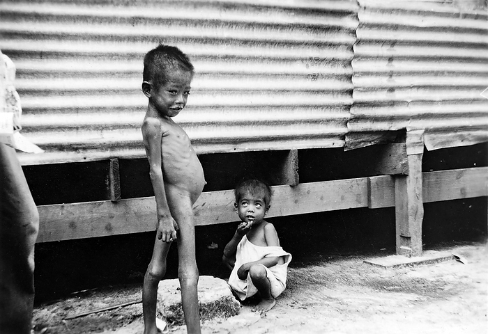 Camp Susuppe  circa 1945  An underfed boy at WWII Susupe Internment Camp in Saipan, ca. 1945  Showa 20 .  The camp was opened in 1944  Showa 19  to house 13.000 Japanese civilians and 5.000 Chamorros, Kakanas and Koreans. It was closed on July 4, 1946  Showa 21 .  The US capture of the Northern Marianas in July 1944 resulted in the first US occupation of Japanese territory.  Japan had strongly committed to defending Saipan because it considered the island part of the last line of defenses for the Japanese homeland. In mid 1944 , nearly 30,000 troops were based on the island. Only 921 of them were taken prisoner.  Photo by MeijiShowa AFLO