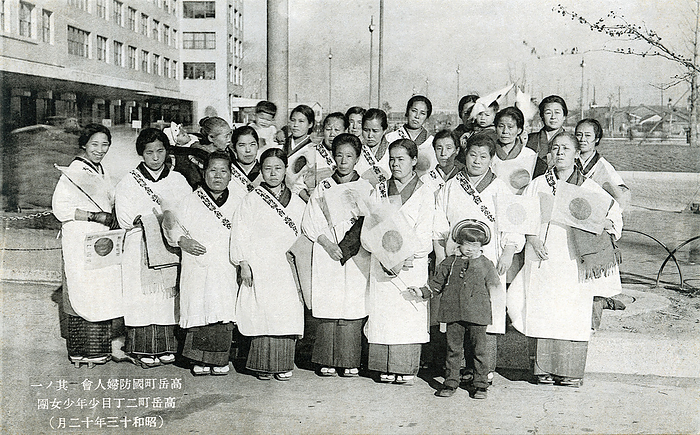 160309 0006   Patriotic Japanes Women A local chapter of the Women s Society for National Defense  Kokubo Fujinkai  in Takaokacho, Nagoya, Aichi Prefecture in December 1938   Showa 13 .  The Kokubo Fujinkai was a patriotic women s association active between 1932  Showa 7  and 1942  Showa 17 . The role of such organizations was to encourage patriotism and to define the ideal relation between women and the nation, generally by emphasizing home The role of such organizations was to encourage patriotism and to define the ideal relation between women and the nation, generally by emphasizing home and motherhood.  Their activities included waving national flags at stations to send soldiers off to war, looking after the wounded or bereaved families, and other chores that aided the war effort. Their white aprons were effectively uniforms and made them easy to recognize.  Caption: Takatake cho National Defense Women s Association Part 1: Takatake cho 2 chome Boys and Girls Club  December 1938   Photo by MeijiShowa AFLO