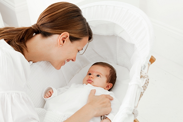 Mother with baby in bassinet
