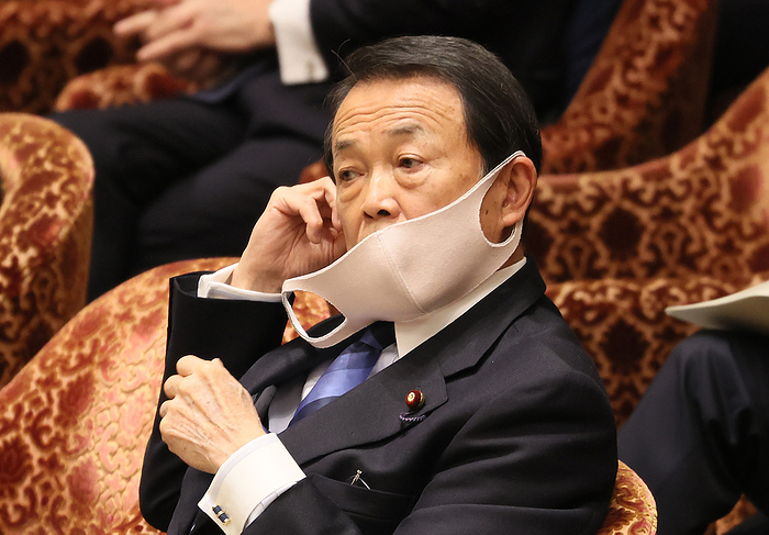 Japanese Prime Minister Shinzo Abe attends Lower House s budget committee session April 28, 2020, Tokyo, Japan   Japanese Finance Minister Taro Aso hanging a face mask from his ear listens to a question at Lower House s budget committee session at the National Diet in Tokyo on Tuesday, April 28, 2020. The government submitted the supplementary budget bill to the Diet on April 27 to fight against outbreak of the new coronavirus.    Photo by Yoshio Tsunoda AFLO 