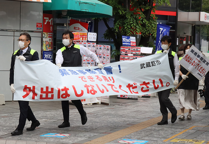 Musashino city officers hold a banner to demand to refrain from going out May 3, 2020, Tokyo, Japan   Musashino city officers hold a banner and a placard to demand to refrain from going out at a shopping arcade in Tokyo on Sunday, May 3, 2020. Prime Minister Shinzo Abe is expecting to extend a state of emergency until end of this month.    Photo by Yoshio Tsunoda AFLO 