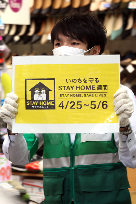 Musashino city officers hold a banner to demand to refrain from going out May 3, 2020, Tokyo, Japan   A Tookyo Metropolitan Government officer holds a placard to demand to refrain from going out at a shopping arcade in Tokyo on Sunday, May 3, 2020. Prime Minister Shinzo Abe is expecting to extend a state of emergency until end of this month.    Photo by Yoshio Tsunoda AFLO 