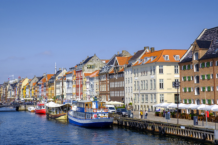 Copenhagen, Denmark Denmark, Copenhagen, Boats moored along Nyhavn canal with colorful townhouses in background