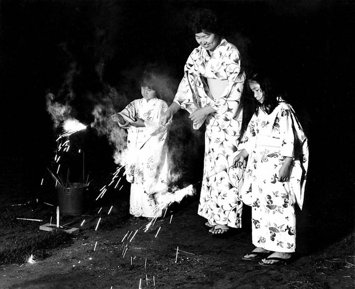 Children playing with fireworks with their mothers, don t forget the fire bucket  1985  Children playing with fireworks with their mothers. Don t forget a bucket for fire extinguishing 