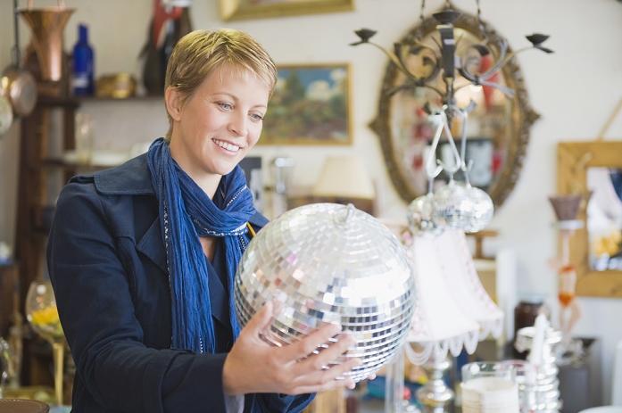 Woman holding a disco ball in a store