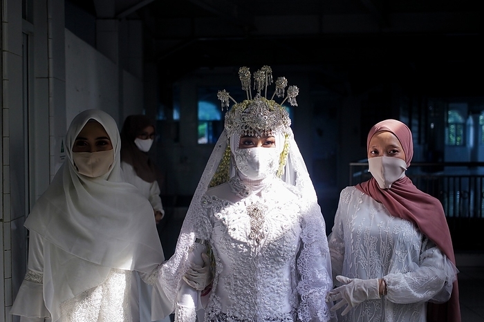 The Marriage ceremony amid concern COVID 19 in Indonesia A bride wears face masks as a precaution, during their marriage ceremony in Bogor, Indonesia, June 6, 2020. The Marriage ceremony amid concern COVID 19, was held inside a home with least number of people, following of social distance and strict health protocol rule.