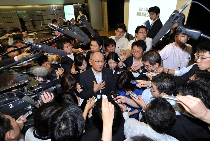Toyota forecasts profit decline Impacted by Earthquake and Strong Yen June 10, 2011, Tokyo, Japan   Executive Vice President Satoshi Ozawa of Toyota Motor Corp. answers questions as he is surrounded by reporters after a news conference at its Tokyo head office on Friday, June 10, 2011.    Toyota forecasts its annual profit to dive 31   due to impact of strong yen and the March 11 earthquake and tsunami. The auto maker expects to post a net profit of  280 billion in the fiscal year ending March 2012, down 31  from  408.1 billion in the last fiscal year.  Photo by Natsuki Sakai AFLO   3615   mis 