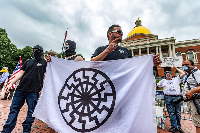 Police Supporters Demonstrate in Boston, U.S. Black Opposition Groups Also Gather in Protest June 27, 2020, Boston, Massachusetts, USA:Men wearing  Nationalist Social Club  shirt holds Black Sun flag  Schwarze Sonne  during a pro police rally outside the Statehouse in Boston.   Photo by Keiko Hiromi AFLO  