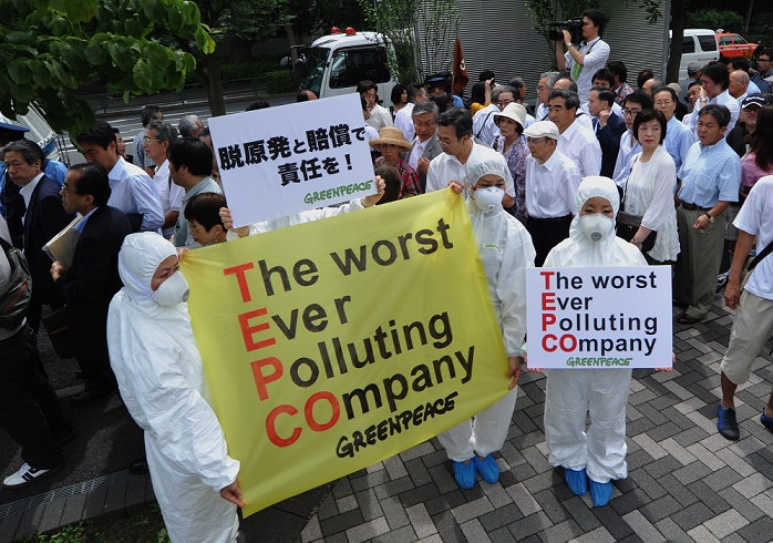 TEPCO Shareholders  Meeting Anti nuclear power plant demonstration outside the venue June 28, 2011, Tokyo, Japan   Amid ongoing protest against the operations of nuclear power plants, shareholders make their way to the general meeting of Tokyo Electric Power Co. in Tokyo on Tuesday, June 28, 2011.   It was the first time the operator of the crippled Fukushima No. 1 nuclear plant faces stockholders since the March 11 earthquake and tsunami that caused reactor meltdowns at the ill fated plant located some 210km northeast of Tokyo. The natural disaster and the nuclear catastrophe not only wiped about  36 billion off its market value but also displaced 50,000 residents because of radiation leaks.  Photo by Natsuki Sakai AFLO   3615   mis 