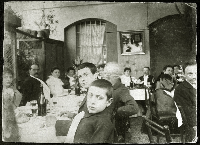 OUTDOOR WEDDING BANQUET BANQUET outdoor wedding in the trattoria of via Magolfa in Milan  in the foreground two little boys, in the background the bride and groom. Italy, 1897.