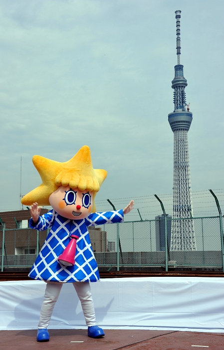 300 days to the opening of the Sky Tree Unveiling of new character  Sorakara chan,  the Tokyo Sky Tree main mascot character meaning  a cute little girl that has come from the sky ,  poses with the 634 meter tall communications tower in the background on the roof of downtown Tokyo building on Wednesday, July 27, 2011. It is just 300 days before the newest Tokyo landmark begins operating in the spring of 2012.  Photo by Natsuki Sakai AFLO   3615 .