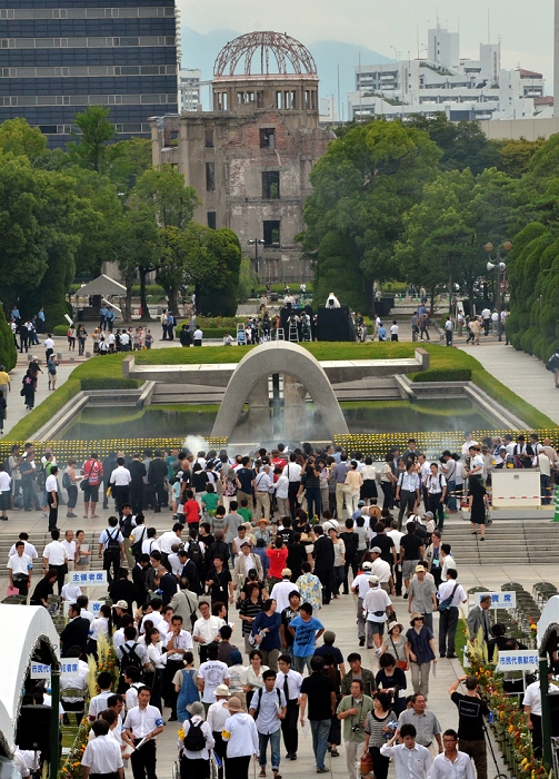 66th Anniversary of Hiroshima  Atomic Bomb Day Peace Memorial Ceremony August 6, 2011, Hiroshima, Japan   People offer prayers at the cenotaph during a memorial ceremony at Peace Memorial Park in Hiroshima on Saturday, August 6, 2011. The skeletal A bomb Dome is in background.  Japan observed the 66th anniversary of the atomic bombing with a moment of silence and the release of doves in a memorial ceremony as the nation struggles to put a different kind of nuclear disaster under The world s first A bomb destroyed most of this western industrial city, killing as many as 100,000 people. A second atomic bombing Aug. 9 that year in Nagasaki killed tens of A second atomic bombing Aug. 9 that year in Nagasaki killed tens of thousands more and prompted the Japanese to surrender.  Photo by Natsuki Sakai AFLO  3615   mis