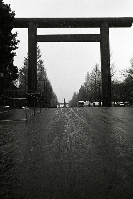 Photo Reportage Yasukuni  as seen by foreigners  An O torii  great gate  marks the entrance to Yasukuni shrine in Tokyo s Kudanshita district Dec 29, 2004. In the Shinto religion  torii  mark the start of scared places an entrance into the world of the divine. Passing under a torii is a means of purification along with the act of cleaning the mouth and hands so as to not defile the shrine. The gate is 25 metres tall and 35 metres wide it is one of the largest tori in Japan.Established in 1869 by the Meiji Emperor to commerate those who died in the Boshin War. The shrine now houses the souls or  kami  of Japan s war dead including 14 A class war criminals who were interned among the 2.5 million war dead in 1978. Visits to the shrine by Japanese Prime Ministers create tensions with Japan s Asian neighbors.  Photo by Bruce Meyer Kenny AFLO 