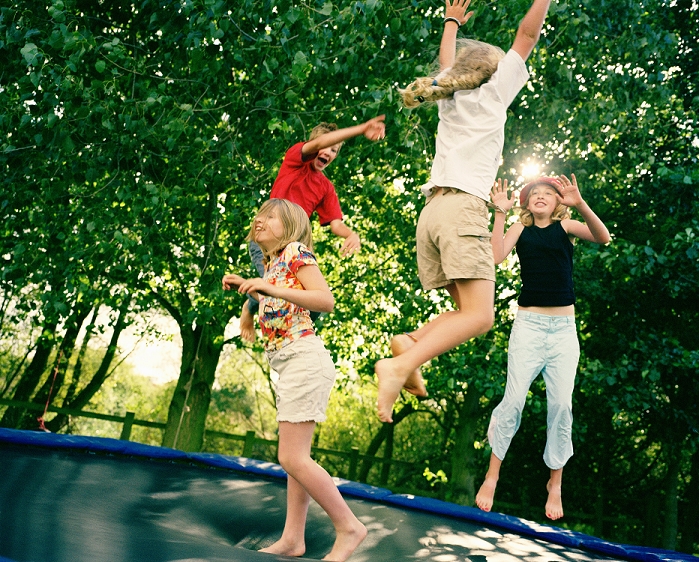 4 children leaping on trampoline