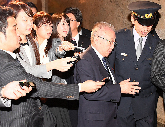 Former LDP Minister in charge of disaster prevention, Shohatsu Konoike, is surrounded by the press after a plenary session of the House of Councillors to cover the issue of the acquisition of state owned land by  Moritomo Gakuen . After a plenary session of the upper house of the Diet, former LDP Minister in charge of disaster prevention, Shohatsu Konoike  second from right , avoids the press trying to talk to him about the issue of the acquisition of state owned land by the Moritomo Gakuen school corporation, at 11:38 a.m. on March 8, 2017, in the Diet, photo by Masahiro Kawada.