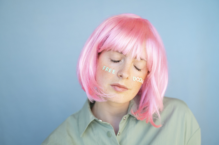 Barcelona, Spain, Young woman wearing pastel pop colorful funky look. Wig, pink, blue, pop, minimal, coloful, pastel, fun, funny, unique, different, colors, creative, pop, hairstyle, look, fashion Young woman wearing pink wig, letters on her face, free doom