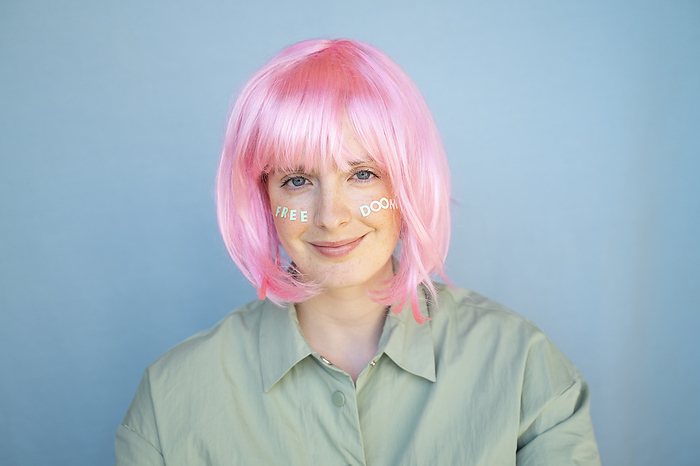 Barcelona, Spain, Young woman wearing pastel pop colorful funky look. Wig, pink, blue, pop, minimal, coloful, pastel, fun, funny, unique, different, colors, creative, pop, hairstyle, look, fashion Young woman wearing pink wig, letters on her face, free doom