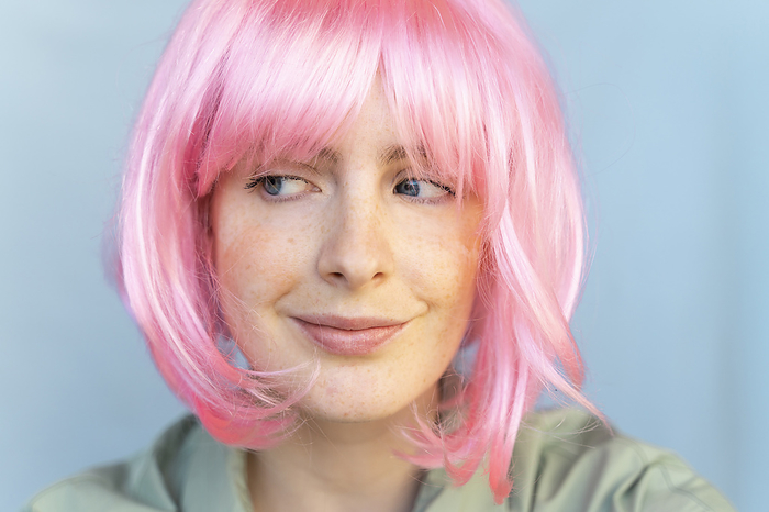 Barcelona, Spain, Young woman wearing pastel pop colorful funky look. Wig, pink, blue, pop, minimal, coloful, pastel, fun, funny, unique, different, colors, creative, pop, hairstyle, look, fashion Portrait of young woman wearing pink wig glancing sideways
