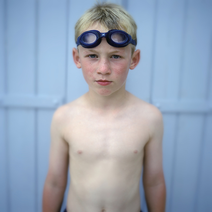 Foreign boy with goggles Portrait Of Young Boy In Swimming Goggles Against Blue Panel Photo by Toby Adamson   Design Pics