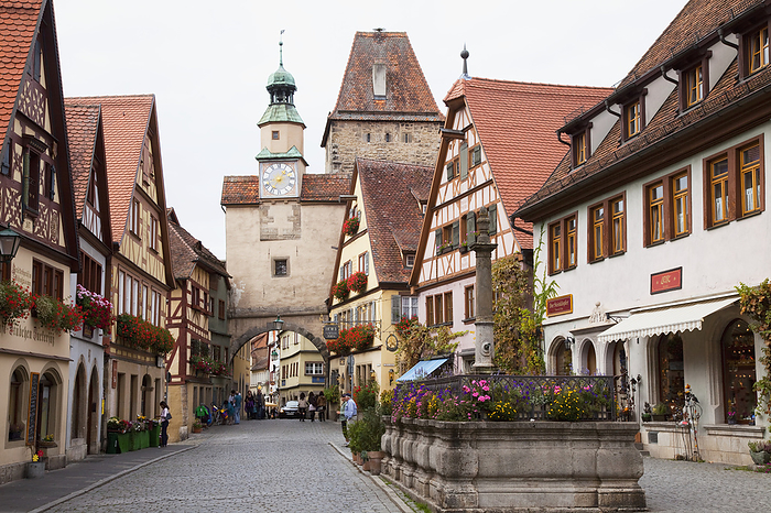 Germany Pedestrians On A Street With A Clock Tower And Archway  Rothenburg Ob Der Tauber Bavaria Germany Photo by Peter Zoeller