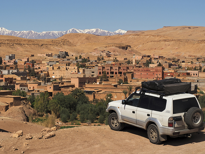 Morocco Ait Ben Haddou Morocco, Ait Benhaddou, 4x4 car on hill overlooking ancient fortified village