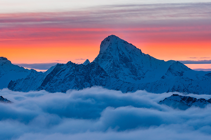 Switzerland Dent Blanc peak over clouds during a winter sunrise in Swiss Alps. Igloo refuge des Pantalons Blancs, Heremence, Sion, Valais canton, Switzerland, Europe., Photo by Giacomo Meneghello