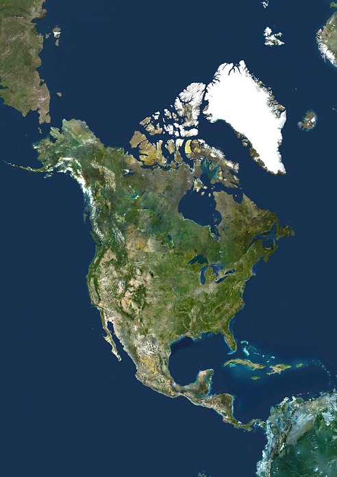 satellite image North America, True Colour Satellite Image. North America. True colour satellite image centred on North America. The North Pole is at top centre. Water is blue, vegetation is green, arid areas are brown, and snow and ice are white. The terrain of North America is marked by mountain ranges on the western coast, deserts in the south west, and large lakes in the north east. The shades of green vary, showing central plains, marshes in the far north, swamps in the south east and forests in the north west. Surrounding North America  clockwise from top  is the Arctic Ocean, Greenland, part of the Atlantic Ocean, the Caribbean Sea and part of South America, and the Pacific Ocean. The image used data from LANDSAT 5   7 satellites.