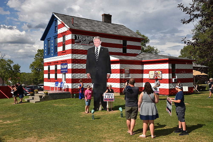 Trump supporters pose for a photo with a giant Donald Trump sign. Trump supporters pose for a photo with a giant Donald Trump sign in Latrobe, Pennsylvania, August 23, 2020, 3:50 p.m. Photo by Issei Suzuki.