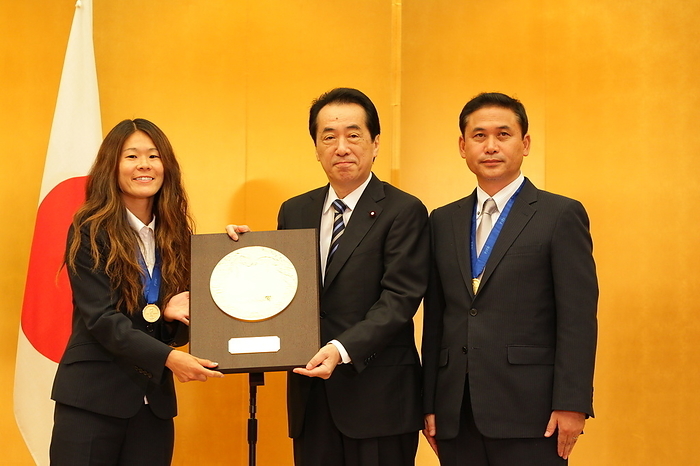 National Honor Prize Awarded to World Cup Winners Nadeshiko Japan Japan women s national football team captain Homare Sawa  L  and head coach Norio Sasaki  R  pose with Japanese Prime Minister Naoto Kan after receiving the People s Honor Award plaque during an award ceremony at the premier s official residence in Tokyo, Japan, August 18, 2011. Japan won the FIFA Women s World Cup Germany 2011.  Photo by JFA AFLO 