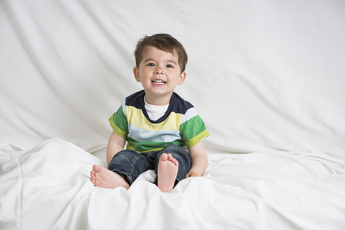 Little boy is sitting on a bed, Photo by Sarah Kastner