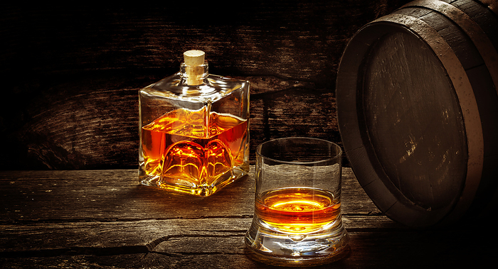 Whiskey bottle and glass, whiskey cellar, whiskey barrels, Photo by fotoknips