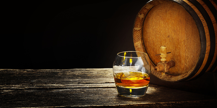Whiskey barrel and whiskey glasses on a wooden table, Photo by fotoknips