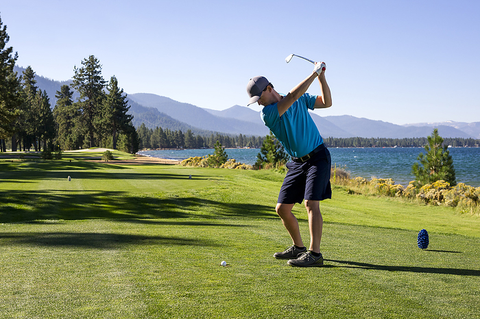 A man teeing off at Edgewood Tahoe in Stateline, Nevada., United States, Nevada, Stateline