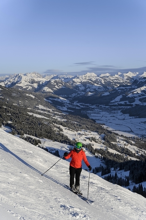 Skier standing on ski slope, mountain panorama in the back, SkiWelt Wilder Kaiser, Brixen im Thale, Tyrol, Austria, Europe