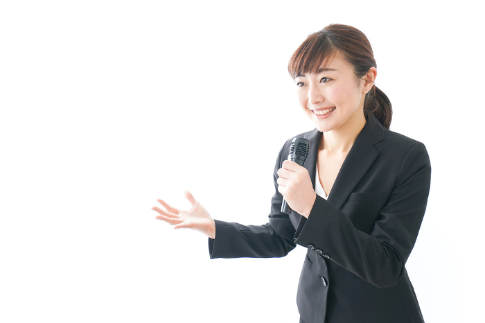 Businesswoman conducting an interview, moderating, or giving a presentation