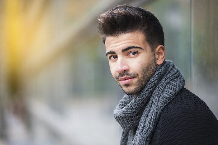 Handsome young man with scarf around neck