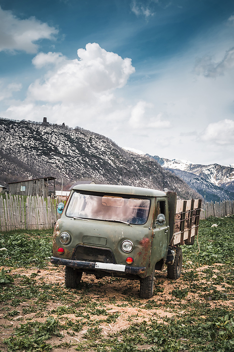 Georgia, Svaneti, Ushguli, Old truck parked in front of mountain village