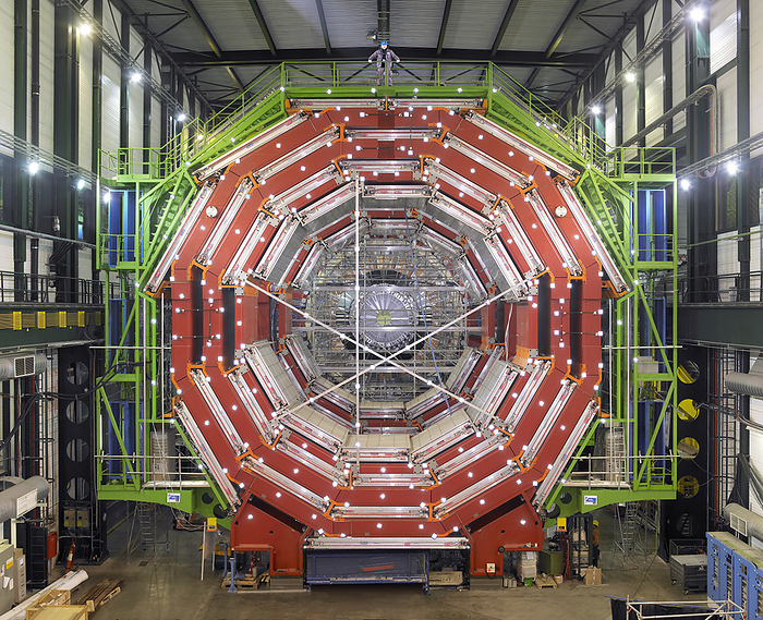 CMS detector, CERN CMS detector. Part of the CMS  compact muon solenoid  detector at CERN  the European particle physics laboratory  near Geneva, Switzerland. The detector will be placed around the large hadron collider  LHC , CERN s highest energy particle accelerator. Proton beams will be accelerated and collided head on in the LHC, and the CMS will detect the resultant particles. The main goal of the experiment is the discovery of the Higgs boson, an elementary particle predicted by the Standard Model of particle physics, but yet to be directly detected  as of 2006 . A pilot run of the LHC is scheduled for summer 2007.