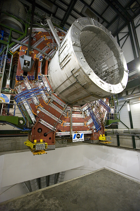A section of the CMS detector, CERN A section of the CMS detector, weighing 1,900 tonnes, about to be lowered 100 metres into an underground chamber in Cessy, France. The CMS  Compact Muon Solenoid  is a detector at the LHC  Large Hadron Collider , at CERN  the European particle physics laboratory  in Switzerland. The CMS was lowered into position between 2006 and 2008 to surround part of the LHC, a 27 kilometre long high energy particle accelerator. The LHC is scheduled to start operating in summer 2008 and will endeavour to probe the inner structure of matter, in order to explain the origin of matter, dark matter and the mysteries of the early universe.