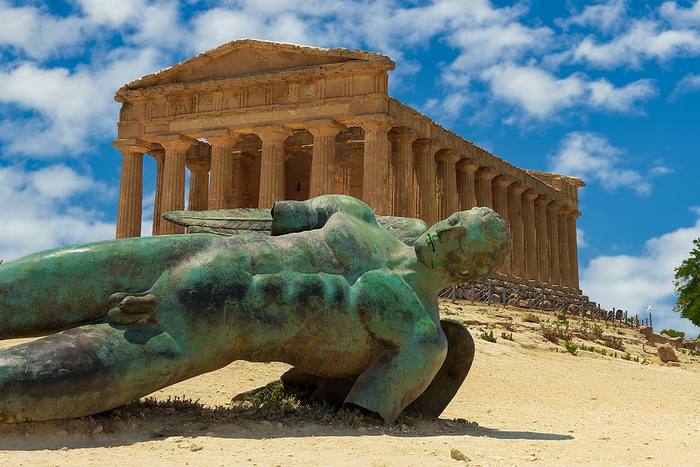 Agrigento Temple of Concordia with statue. Ancient Greek Doric temple with Fallen Icarus bronze statue in Valley of the Temples Temple of Concordia with statue, ancient Greek Doric temple with Fallen Icarus bronze statue in Valley of the Temples, Agrigento, UNESCO World Heritage Site, Sicily, Italy, Europe, Photo by bestravelvideo
